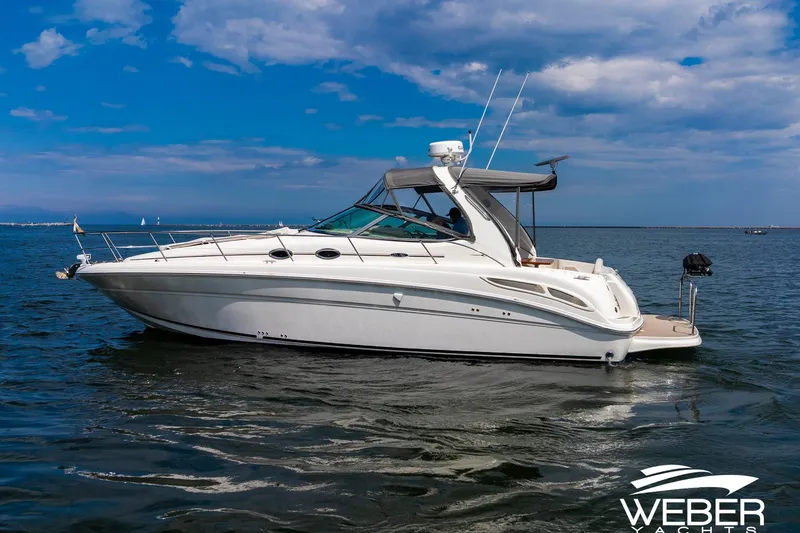 Slide: The Image of A 2005 Sea Ray 360 Sundancer on the water with a clear sky in the background. - 34