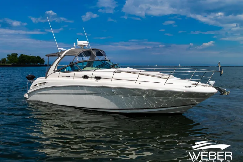 Slide: The Image of 2005 Sea Ray 360 Sundancer on calm water with a blue sky in the background. - 37