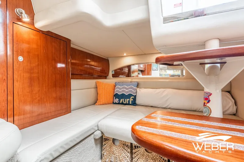 Slide: The Image of Interior of the 2005 Sea Ray 360 Sundancer with cozy seating area and wooden table. - 27