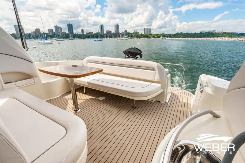 Slide: The Image of The image shows the deck of a 2005 Sea Ray 360 Sundancer with a view of the skyline. - 5