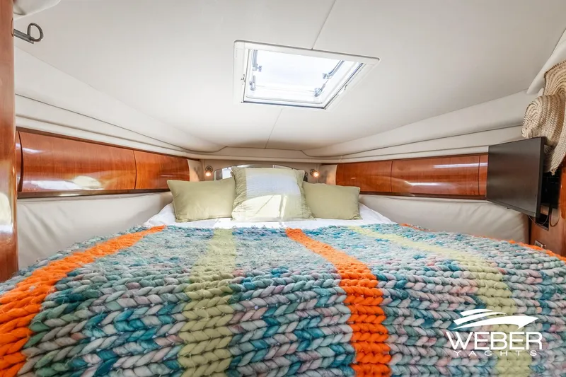Slide: The Image of Cabin of the 2005 Sea Ray 360 Sundancer with a cozy bed and skylight. - 26