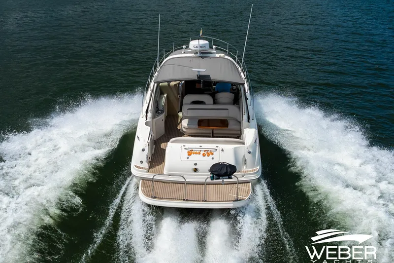 Slide: The Image of A 2005 Sea Ray 360 Sundancer cruising on water, showing the stern and wake. - 44