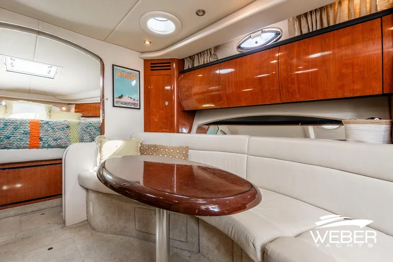 Slide: The Image of Interior of a 2005 Sea Ray 360 Sundancer with elegant seating area and wooden table. - 28