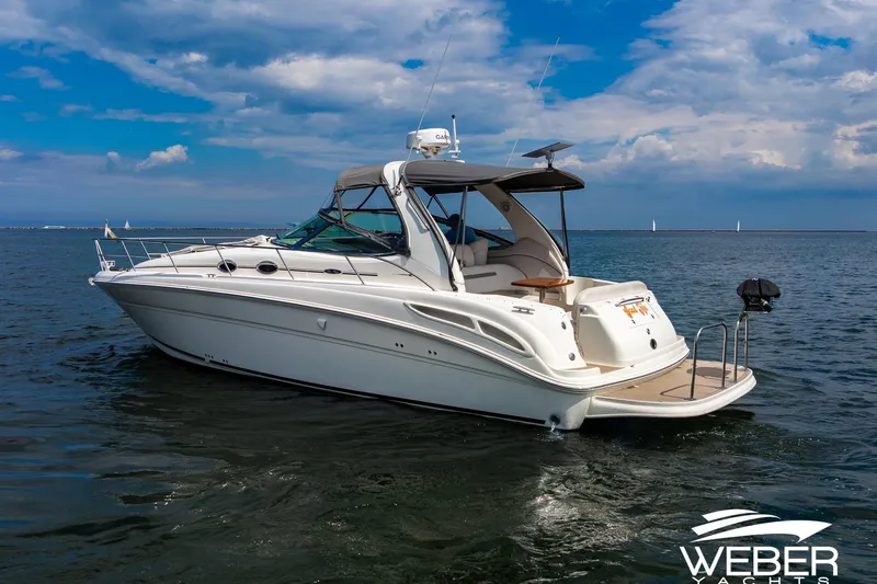 Slide: The Image of 2005 Sea Ray 360 Sundancer on calm water with clear skies. - 33