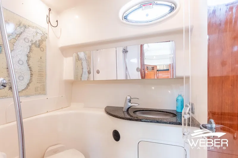 Slide: The Image of Interior view of a boat bathroom with sink, mirror, and map on the wall. - 31