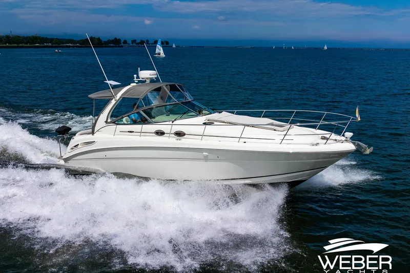 Slide: The Image of A 2005 Sea Ray 360 Sundancer cruising swiftly on the water. - 3