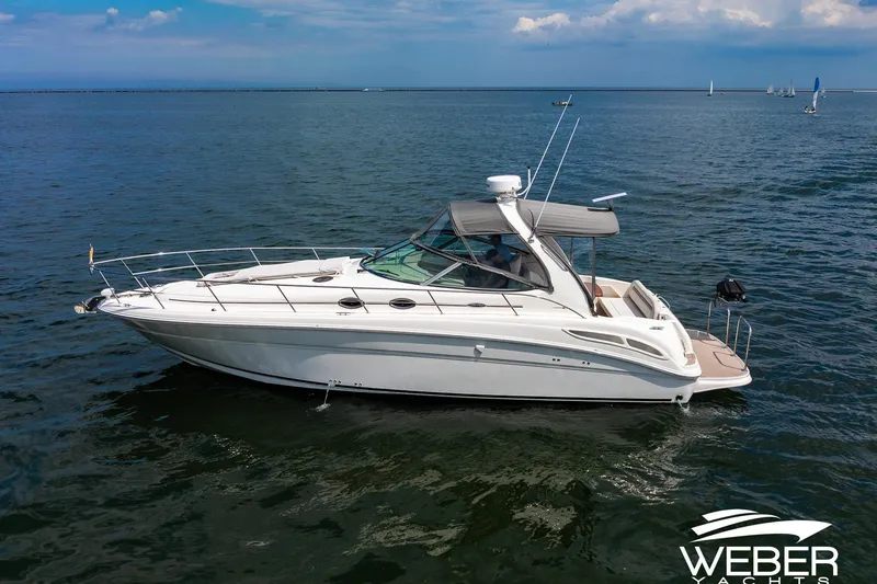 Slide: The Image of A 2005 Sea Ray 360 Sundancer on calm water with a clear sky. - 41