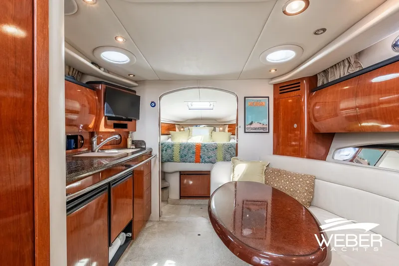 Slide: The Image of Interior of a 2005 Sea Ray 360 Sundancer with a kitchen and seating area. - 24