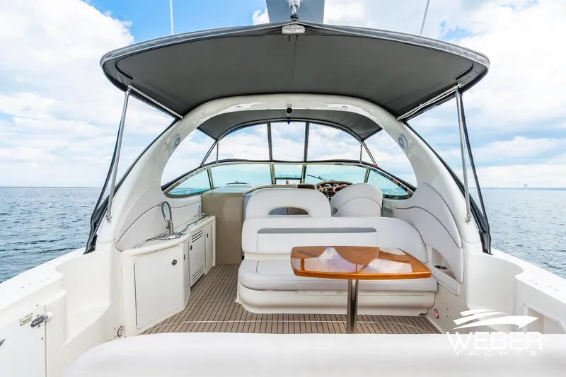 Slide: The Image of The image shows the cockpit of a 2005 Sea Ray 360 Sundancer with seating area and table. - 23