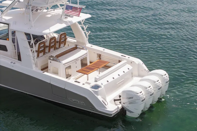 Slide: The Image of 2017 Boston Whaler 420 Outrage boat with four Mercury engines on clear water. - 10