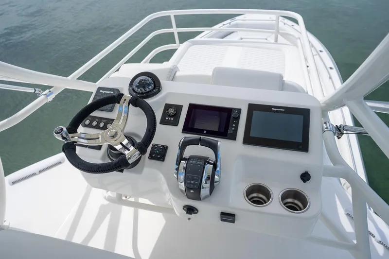 Slide: The Image of Control panel of 2017 Boston Whaler 420 Outrage boat with steering wheel and navigation screens. - 40