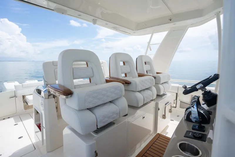 Slide: The Image of Luxurious interior of 2017 Boston Whaler 420 Outrage boat with plush seating and helm controls. - 34