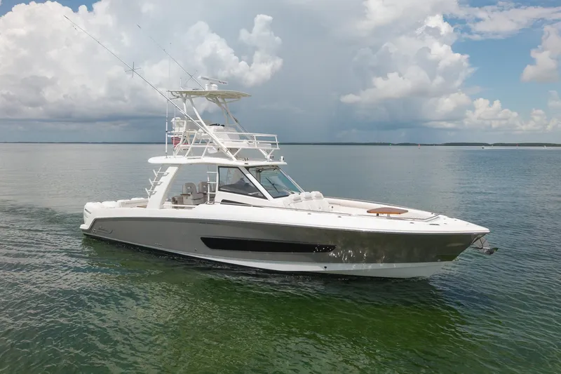 Slide: The Image of 2017 Boston Whaler 420 Outrage boat cruising on calm waters under cloudy skies. - 8