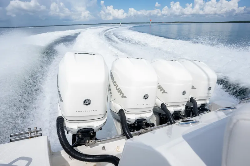 Slide: The Image of 2017 Boston Whaler 420 Outrage with four Mercury outboard engines on open water. - 23