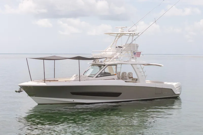 Slide: The Image of 2017 Boston Whaler 420 Outrage boat on calm water under cloudy sky. - 3