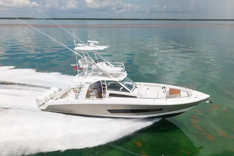 Slide: The Image of 2017 Boston Whaler 420 Outrage cruising on clear waters under a cloudy sky. - 17