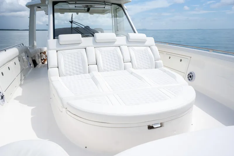 Slide: The Image of 2017 Boston Whaler 420 Outrage boat with luxurious white seating on calm water. - 36