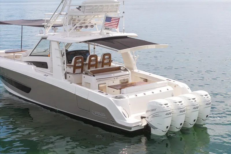 Slide: The Image of 2017 Boston Whaler 420 Outrage boat with four Mercury engines on calm water. - 1
