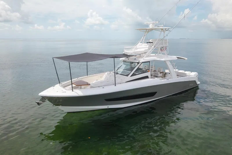 Slide: The Image of 2017 Boston Whaler 420 Outrage boat on calm water, featuring sleek design and spacious deck. - 6