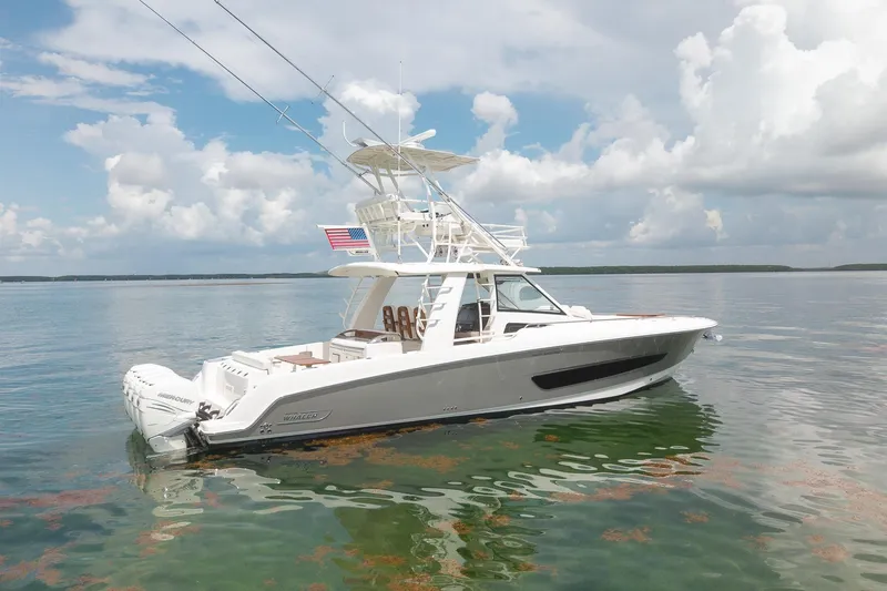 The Image of 2017 Boston Whaler 420 Outrage boat on calm water under a cloudy sky. - 0