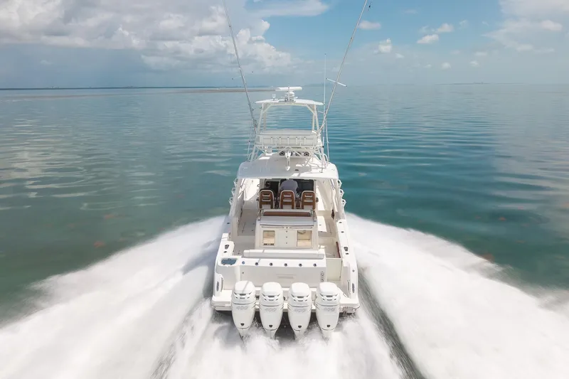 Slide: The Image of 2017 Boston Whaler 420 Outrage cruising on calm ocean waters, rear view. - 14