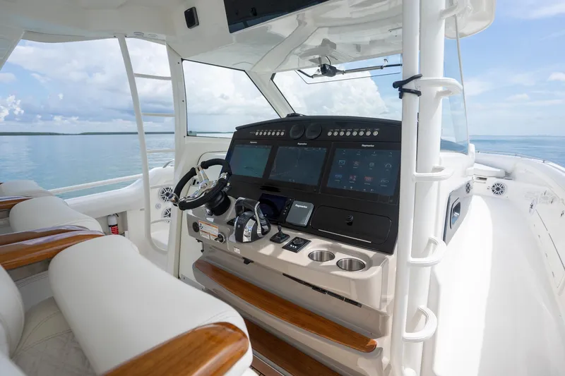 Slide: The Image of Interior view of 2017 Boston Whaler 420 Outrage boat cockpit with modern controls and ocean backdrop. - 26