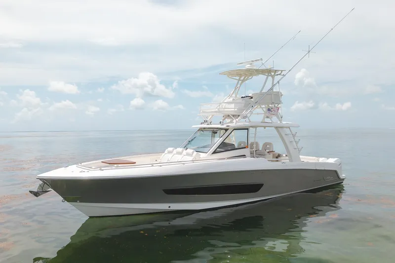 Slide: The Image of 2017 Boston Whaler 420 Outrage boat on calm water under a cloudy sky. - 2