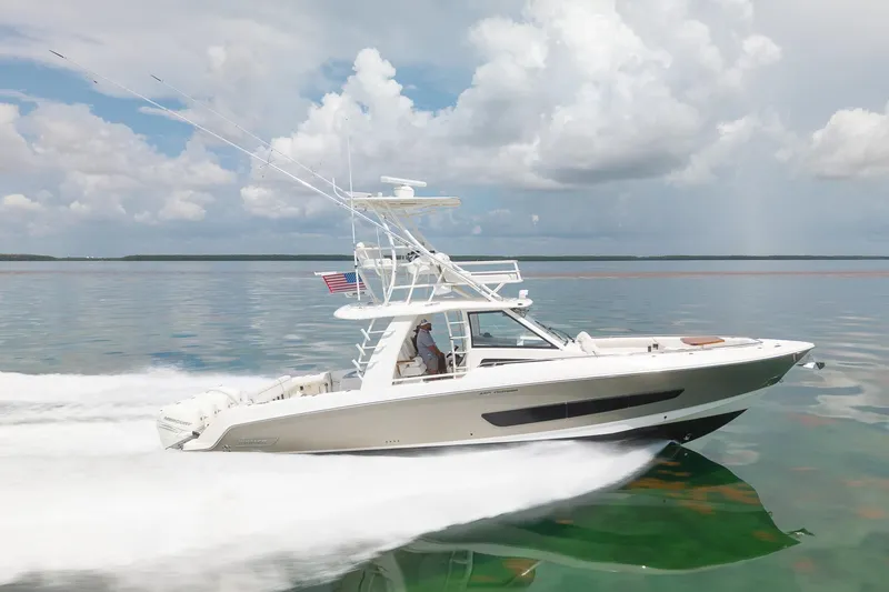 Slide: The Image of 2017 Boston Whaler 420 Outrage cruising on calm waters under a cloudy sky. - 16