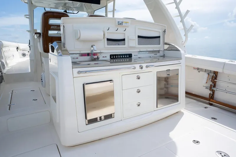 Slide: The Image of 2017 Boston Whaler 420 Outrage boat interior with sleek kitchen amenities and storage. - 28