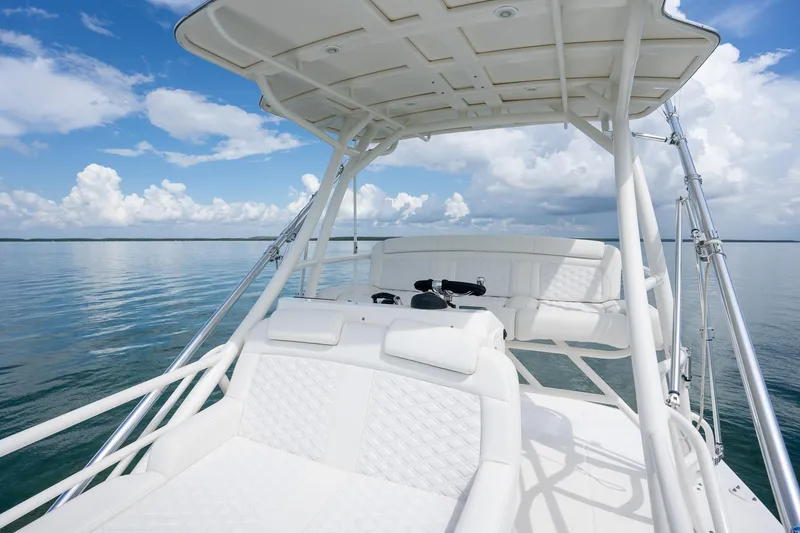 Slide: The Image of 2017 Boston Whaler 420 Outrage boat interior with white seating and ocean view. - 38