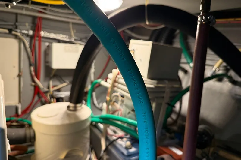Slide: The Image of Engine room of 1985 Tollycraft 34 Sundeck Motor Yacht with hoses and wiring. - 44