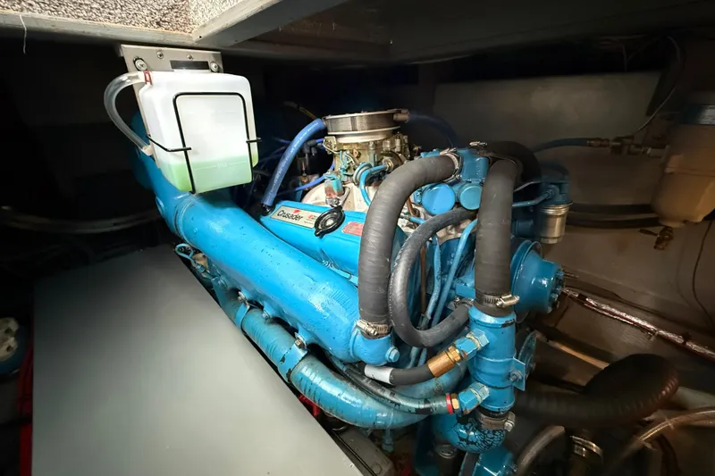Slide: The Image of Engine compartment of a 1985 Tollycraft 34 Sundeck Motor Yacht, featuring a blue engine. - 45