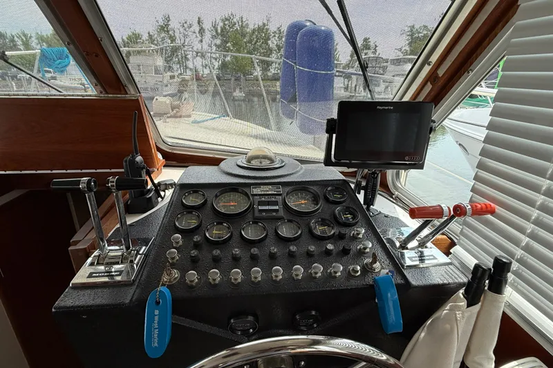 Slide: The Image of Helm of 1985 Tollycraft 34 Sundeck Motor Yacht with gauges and controls. - 17