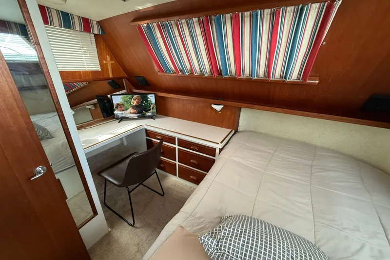 Slide: The Image of Cozy cabin interior of 1985 Tollycraft 34 Sundeck Motor Yacht with desk and bed. - 32
