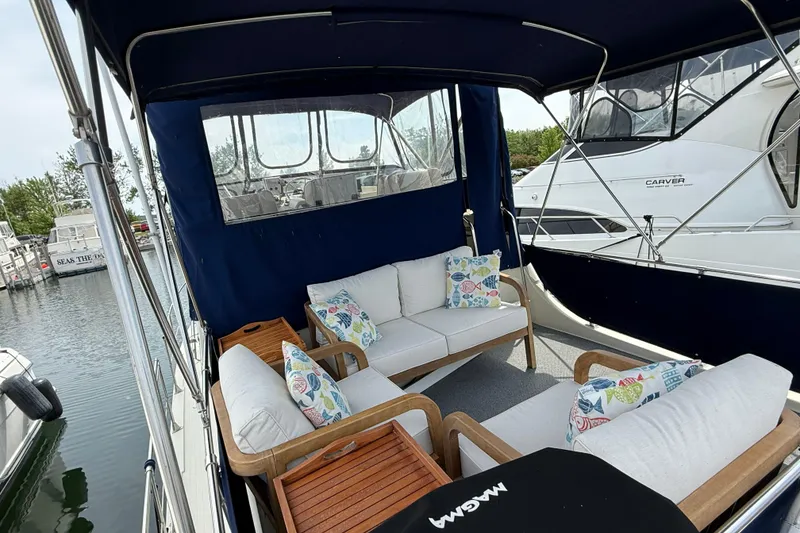 Slide: The Image of 1985 Tollycraft 34 Sundeck Motor Yacht with cozy outdoor seating and colorful cushions. - 9