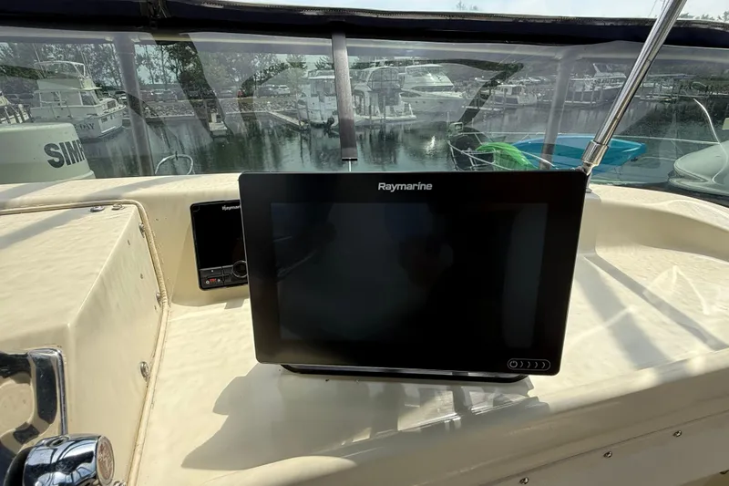Slide: The Image of 1985 Tollycraft 34 Sundeck Motor Yacht helm with Raymarine navigation display. - 11
