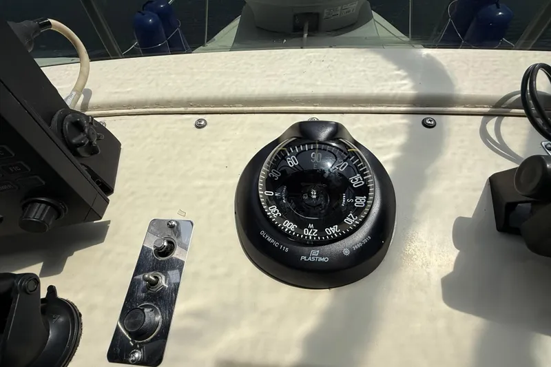 Slide: The Image of Compass and controls on 1985 Tollycraft 34 Sundeck Motor Yacht dashboard. - 14
