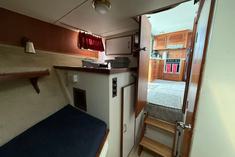 Slide: The Image of 1985 Tollycraft 34 Sundeck Motor Yacht interior with cozy cabin and wooden kitchen. - 40