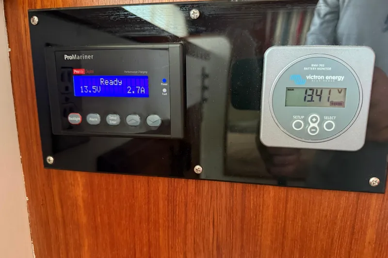 Slide: The Image of Battery monitors on 1985 Tollycraft 34 Sundeck Motor Yacht, displaying voltage and current readings. - 33