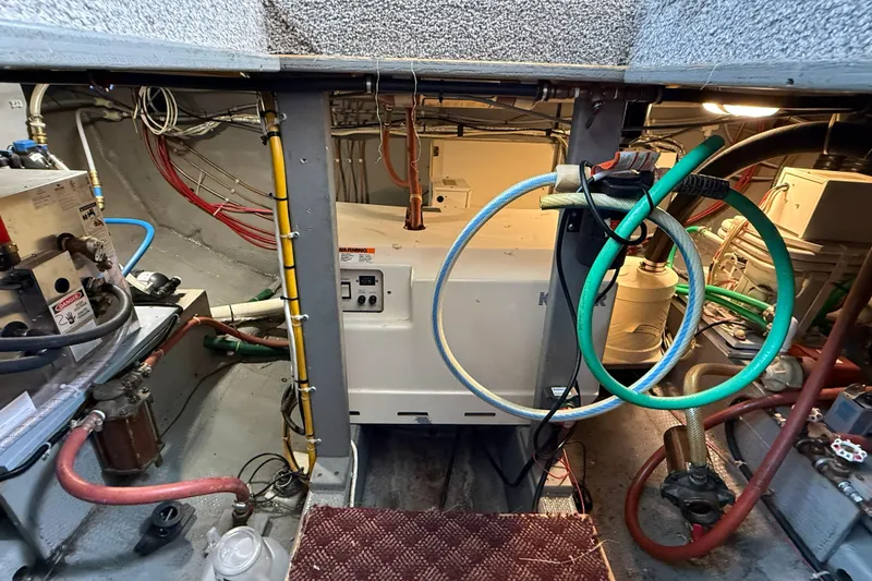 Slide: The Image of Engine room of 1985 Tollycraft 34 Sundeck Motor Yacht with visible wiring and equipment. - 41