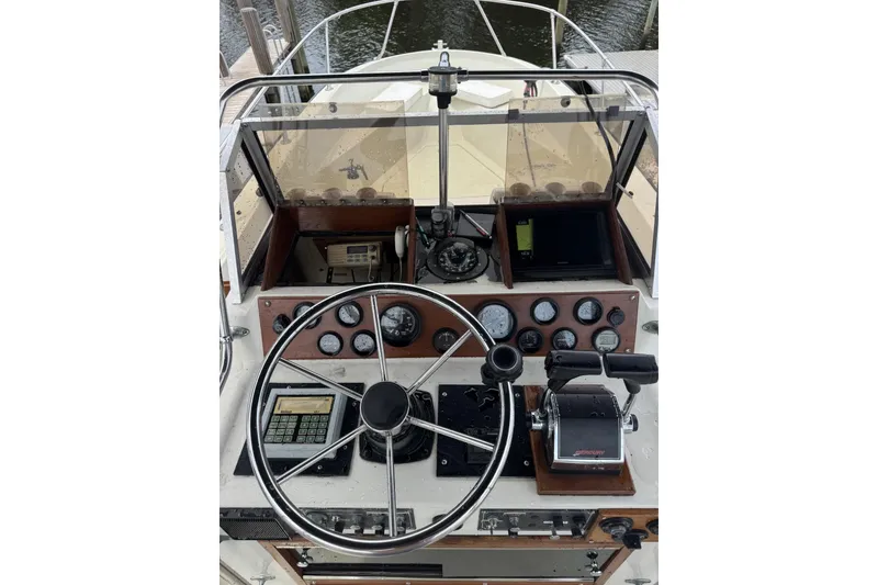 Slide: The Image of 1983 Boston Whaler 21 Outrage boat dashboard with steering wheel and navigation instruments. - 15
