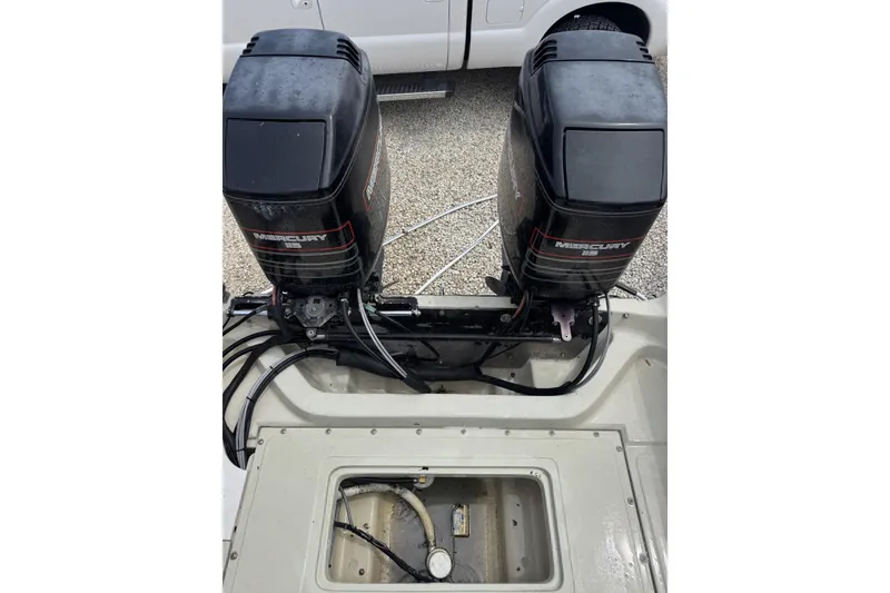 Slide: The Image of Twin Mercury outboard engines on a 1983 Boston Whaler 21 Outrage boat. - 11