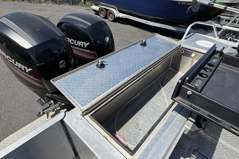 Slide: The Image of 2018 Thunder Jet Pilot 26' boat with dual Mercury outboard engines and storage compartment. - 23