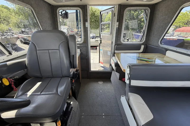Slide: The Image of Interior of 2018 Thunder Jet Pilot 26' boat with seating and table. - 18