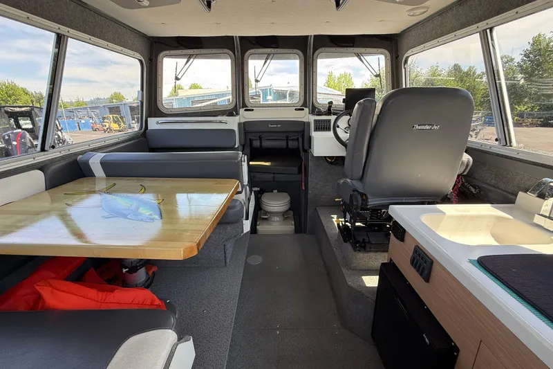 Slide: The Image of Interior of 2018 Thunder Jet Pilot 26' boat with seating, table, and helm. - 6