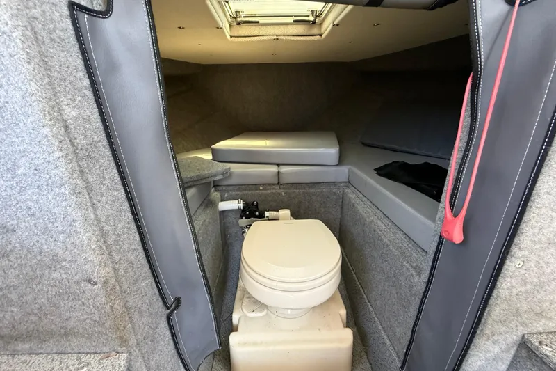 Slide: The Image of 2018 Thunder Jet Pilot 26' cabin interior with toilet and seating area. - 17