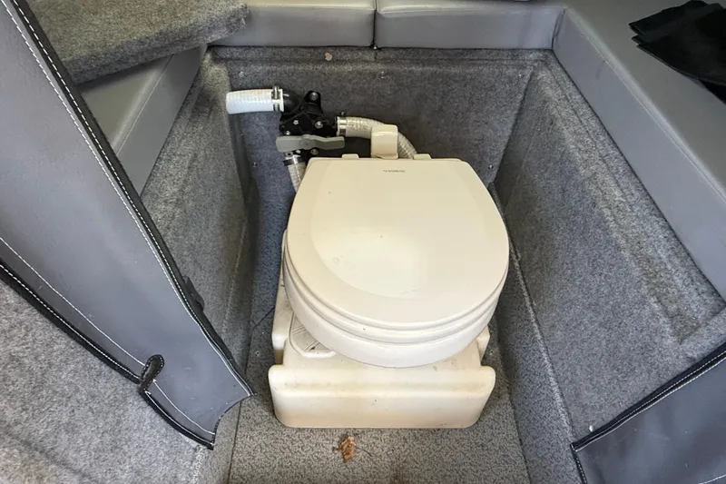 Slide: The Image of 2018 Thunder Jet Pilot 26' boat interior with compact marine toilet setup. - 16