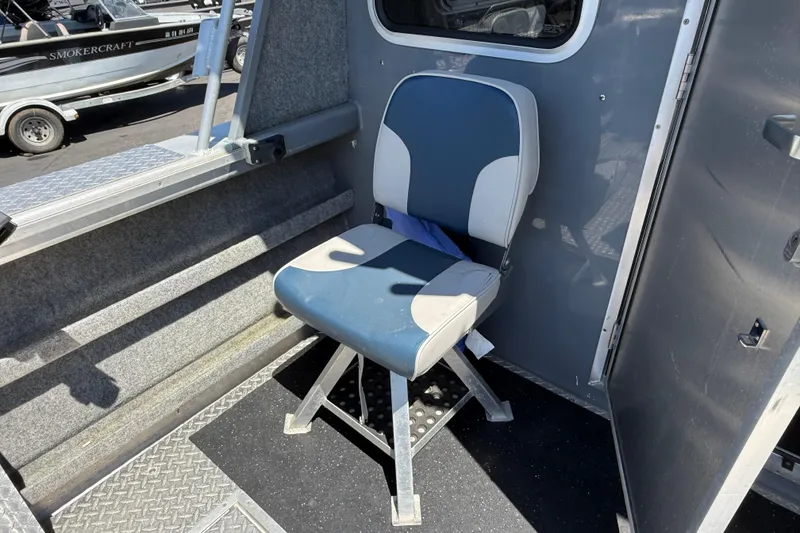 Slide: The Image of 2018 Thunder Jet Pilot 26' interior with blue and gray seating. - 20