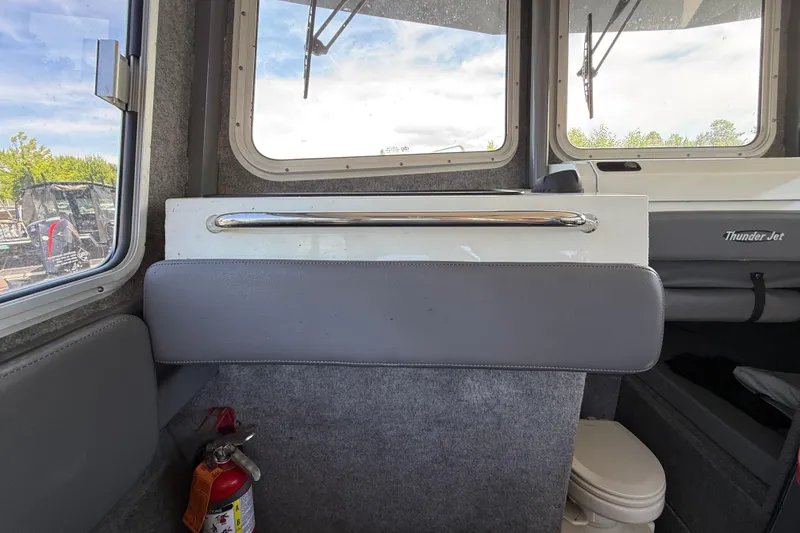 Slide: The Image of Interior of a 2018 Thunder Jet Pilot 26' boat with windows and safety equipment. - 10