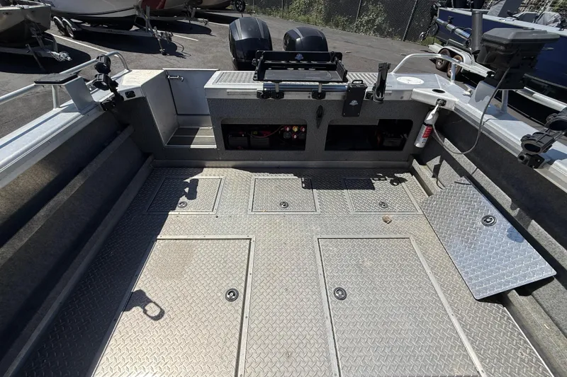 Slide: The Image of 2018 Thunder Jet Pilot 26' boat interior with diamond plate flooring and storage compartments. - 19